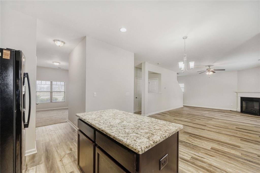 323 Bandelier Circle Hampton, GA 30228 - Photo 10 of 28 a kitchen with kitchen island a sink dishwasher and refrigerator