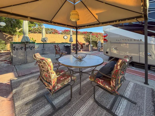 a view of a two chairs in the patio