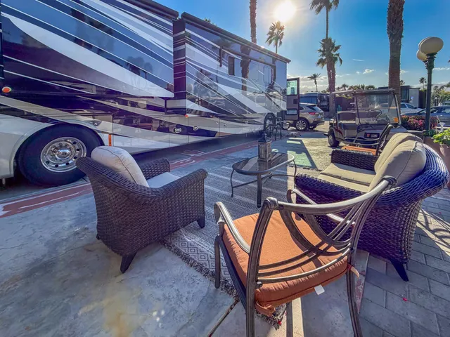 a view of a chairs and table in the balcony