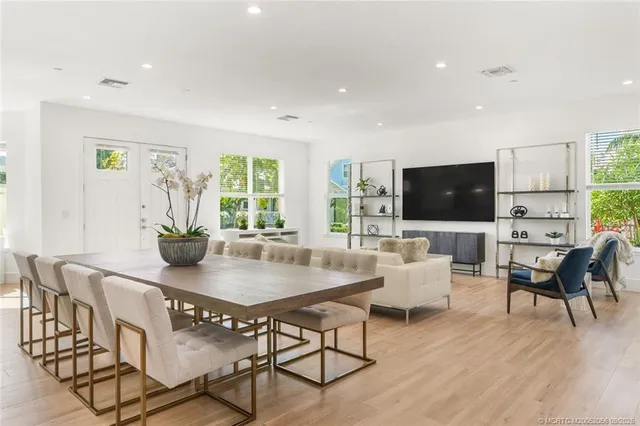 a dining room with furniture and wooden floor