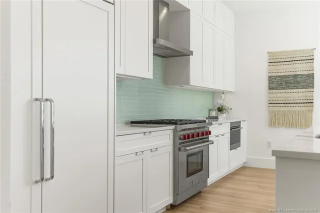 a living room with stainless steel appliances kitchen island granite countertop furniture and wooden floor