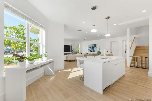 a kitchen that has a sink and a stove in it