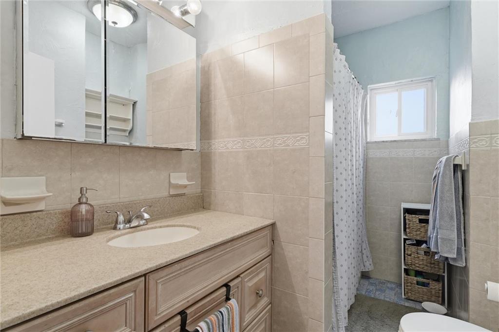 633 Gettysburg Street Pittsburgh, PA 15206 - Photo 23 of 32 a bathroom with a sink and a mirror