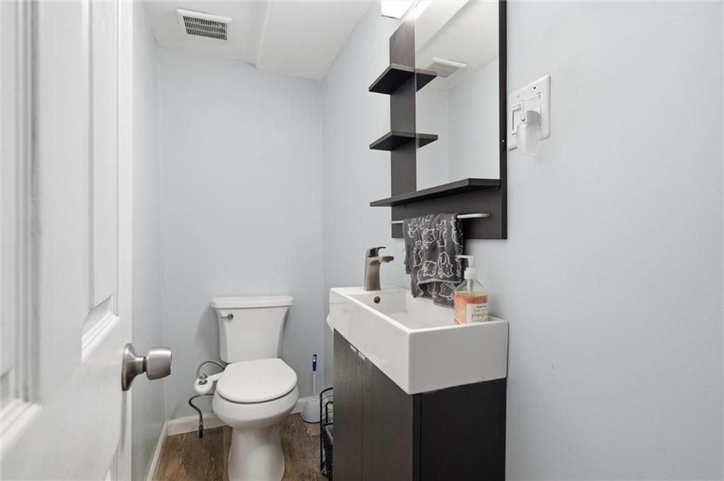 633 Gettysburg Street Pittsburgh, PA 15206 - Photo 6 of 32 a bathroom with a toilet sink and mirror