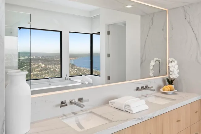 a kitchen with white cabinets and sink