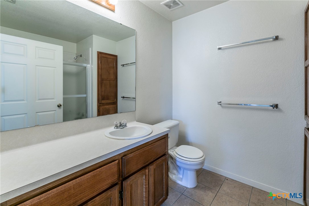 1001 Cherokee Trail Kempner, TX 76522 - Photo 11 of 18 a bathroom with a sink a toilet and shower