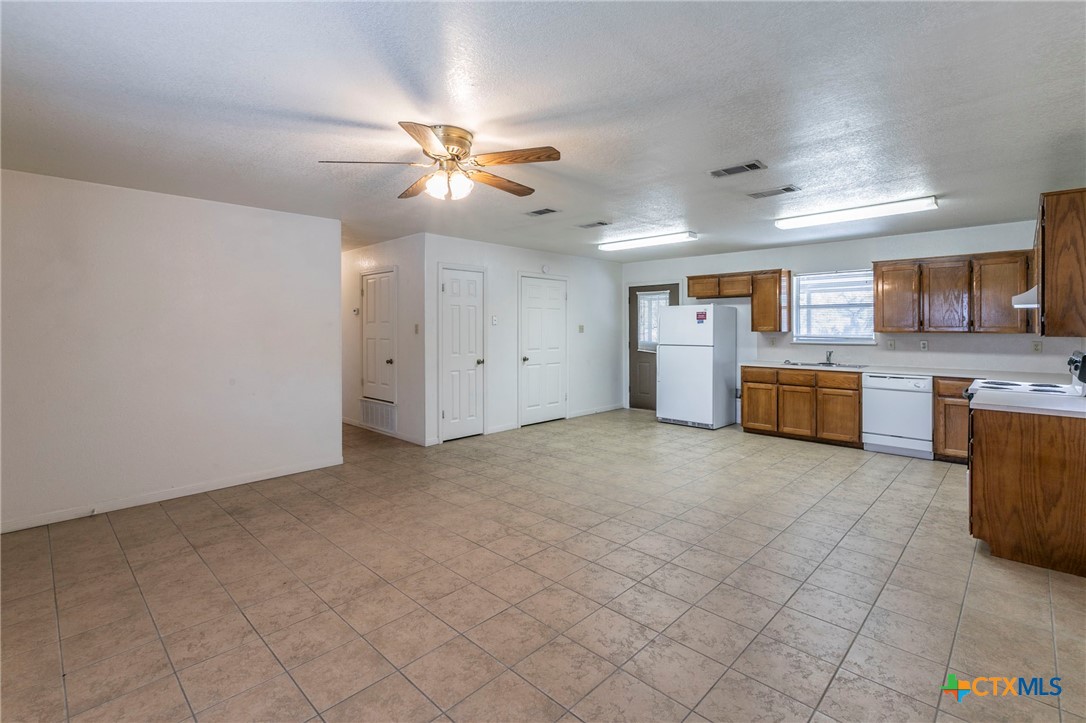 1001 Cherokee Trail Kempner, TX 76522 - Photo 3 of 18 a view of kitchen with granite countertop cabinets and refrigerator