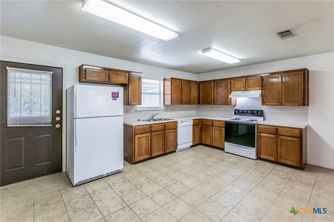 1001 Cherokee Trail Kempner, TX 76522 - Photo 5 of 18 a kitchen with a refrigerator sink and microwave
