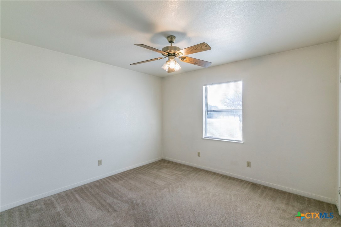 1001 Cherokee Trail Kempner, TX 76522 - Photo 9 of 18 an empty room with a window and a fan