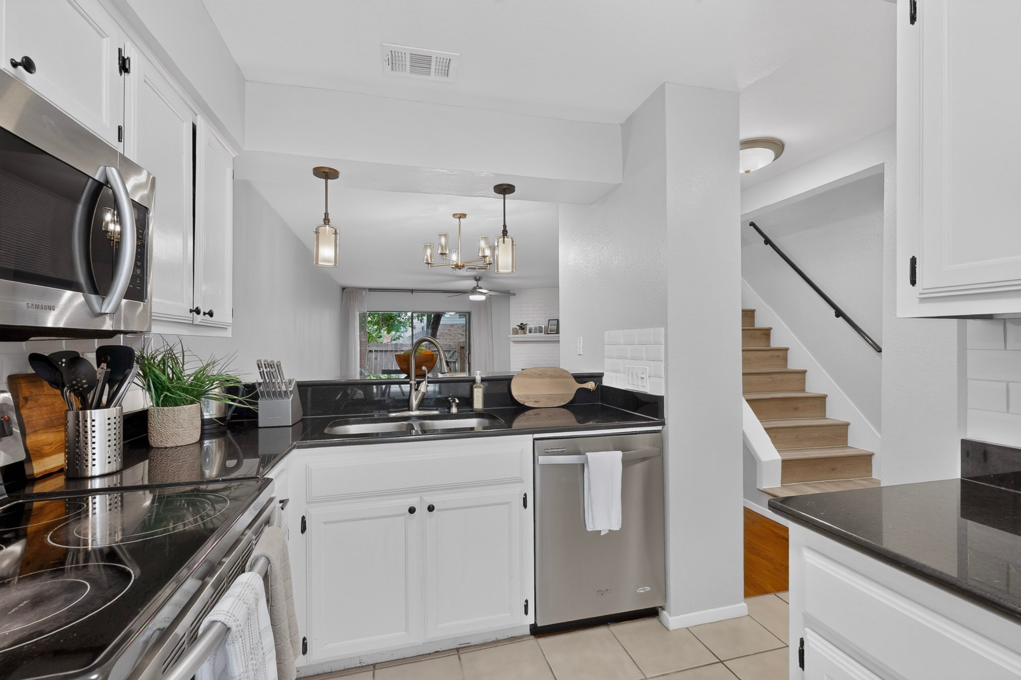 3801 Menchaca Road, Unit 25 Austin, TX 78704 - Photo 9 of 27 Kitchen with granite countertops, stainless steel appliances, and white cabinets
