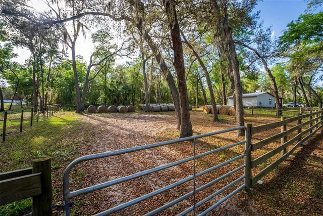 a backyard of a house with table and chairs