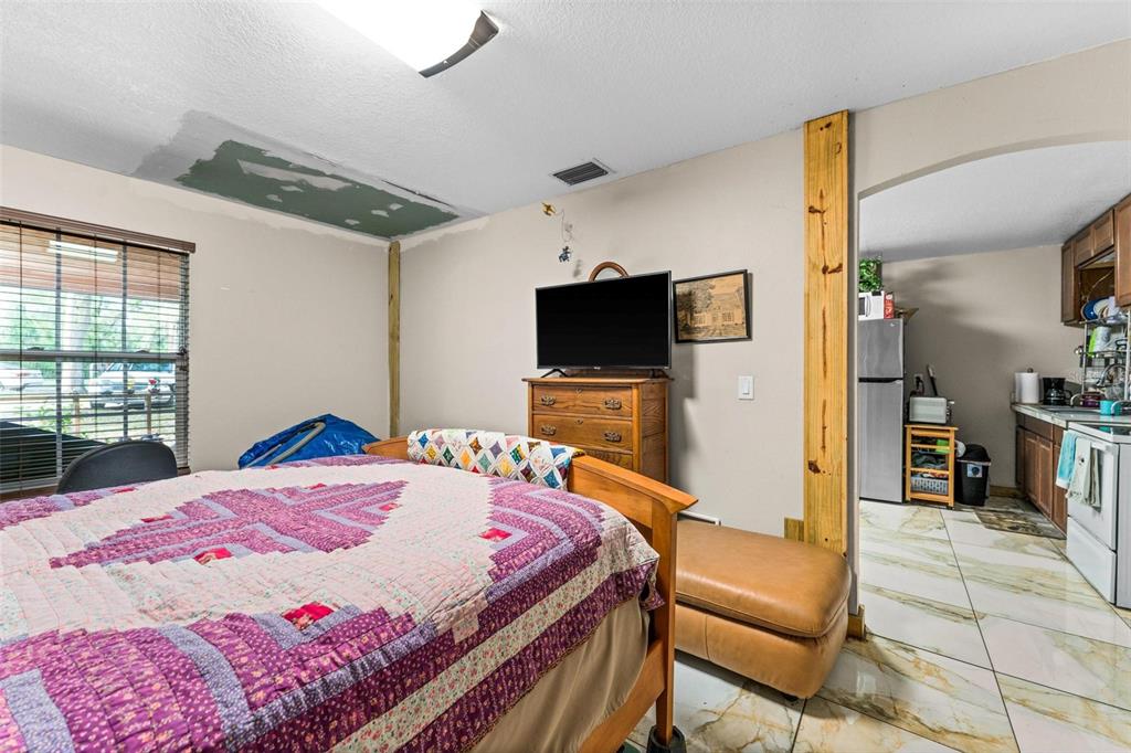 Fishermans Road Paisley, FL 32767 - Photo 44 of 77 a bedroom with a bed and glass windows