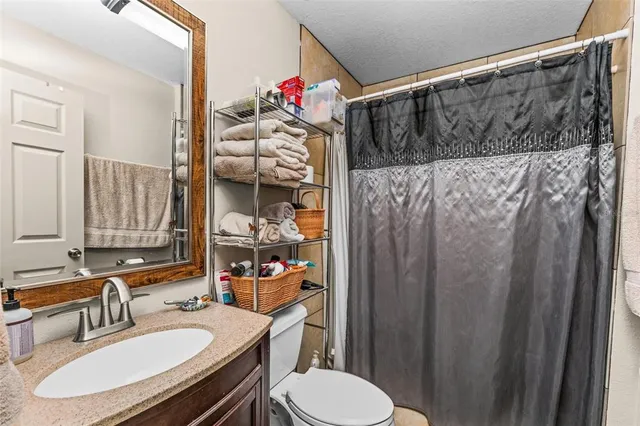 a view of a swimming pool with a lawn chairs and plants