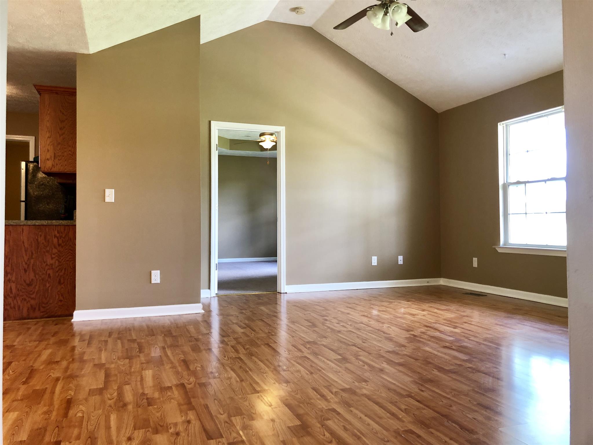 1427 Longview Road Unionville, TN 37180 - Photo 3 of 11 a view of an empty room with window and wooden floor