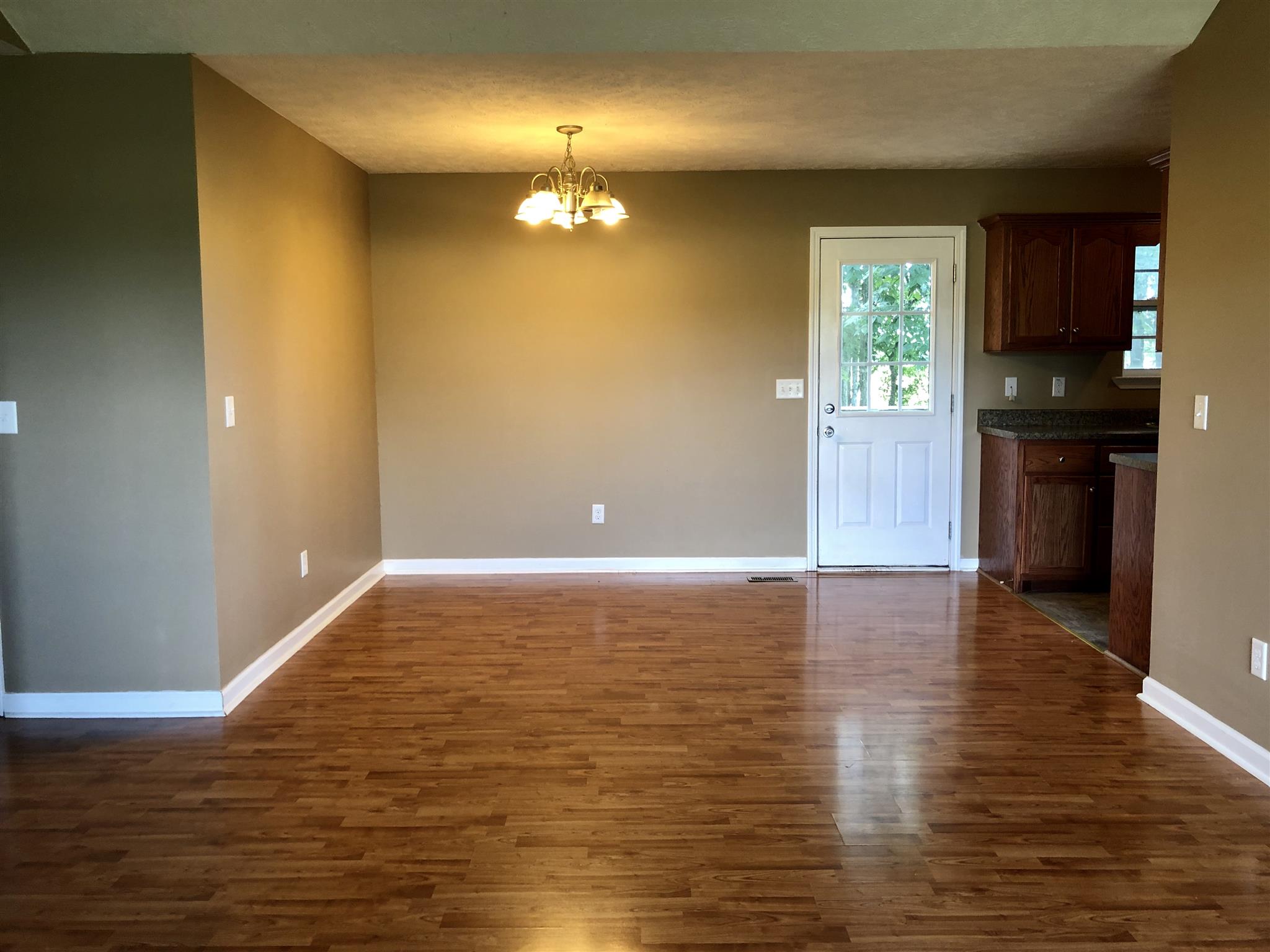 1427 Longview Road Unionville, TN 37180 - Photo 4 of 11 a view of an empty room with window and wooden floor