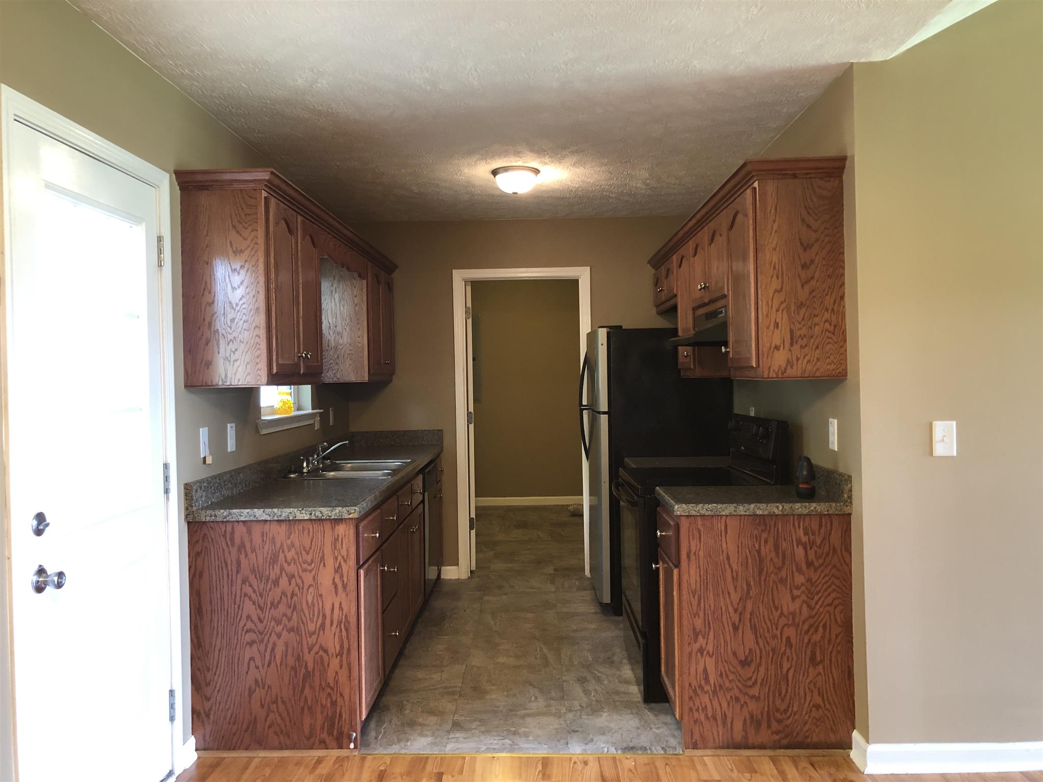 1427 Longview Road Unionville, TN 37180 - Photo 5 of 11 a kitchen with granite countertop a refrigerator and a sink