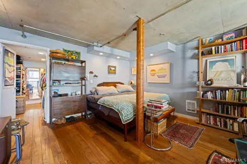 a bedroom with furniture and a book shelf