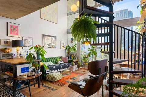 a living room with furniture and a potted plant