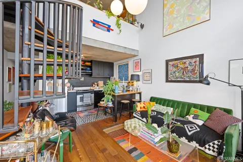 a living room filled with furniture and a book shelf