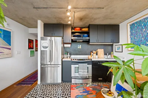a kitchen with stainless steel appliances granite countertop a refrigerator and a stove