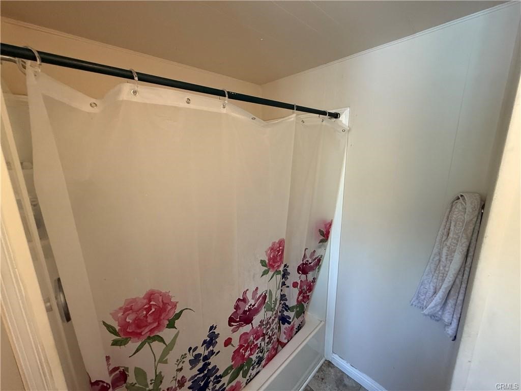 12700 Elliot, Unit 456 El Monte, CA 91732 - Photo 27 of 37 a bathroom with a shower curtain and a window