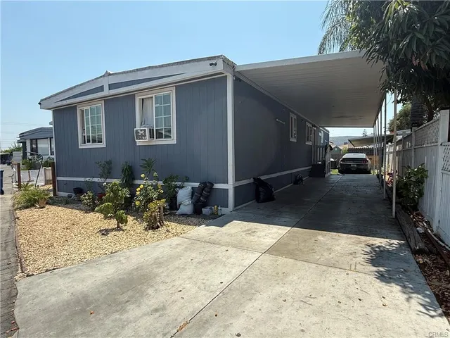 a view of a house with yard and sitting area