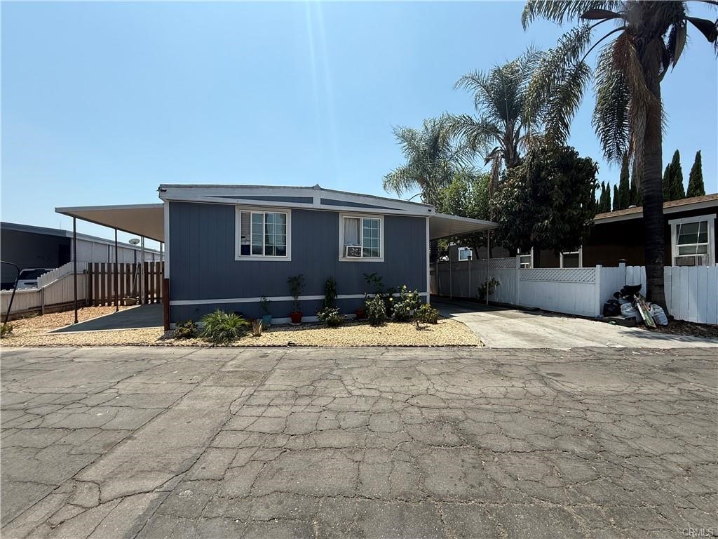 12700 Elliot, Unit 456 El Monte, CA 91732 - Photo 6 of 37 a front view of a house with a yard