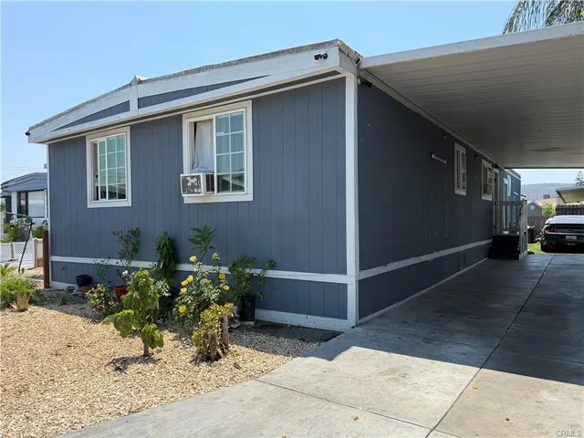 a backyard of a house with potted plants