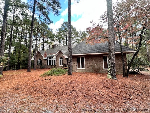 36 Edinburgh Lane Pinehurst, NC 28374 - Photo 2 of 4 a front view of a house with a yard covered in snow