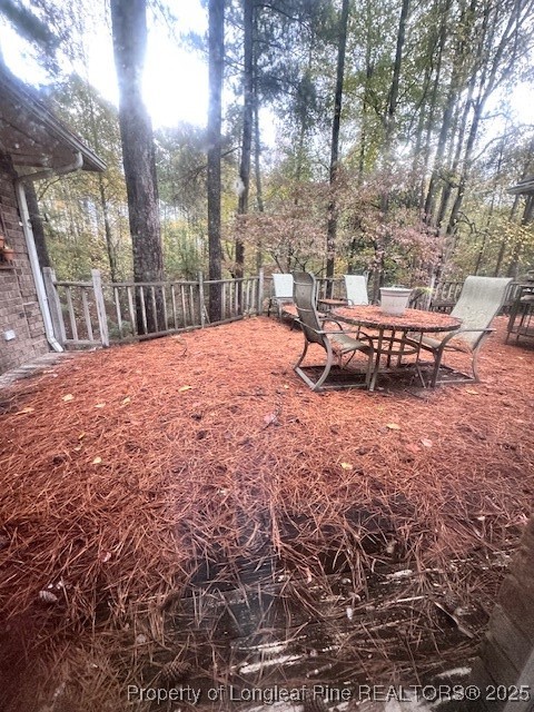36 Edinburgh Lane Pinehurst, NC 28374 - Photo 4 of 4 a backyard of a house with table and chairs