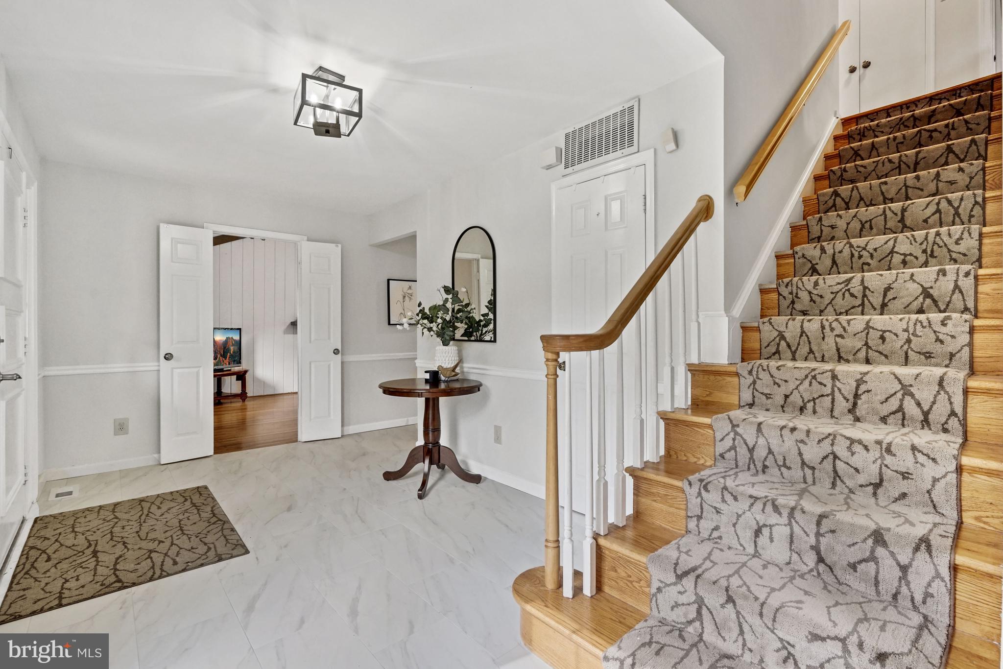 9421 Reach Road Potomac, MD 20854 - Photo 5 of 54 Foyer w/ carpeted runner leading upstairs