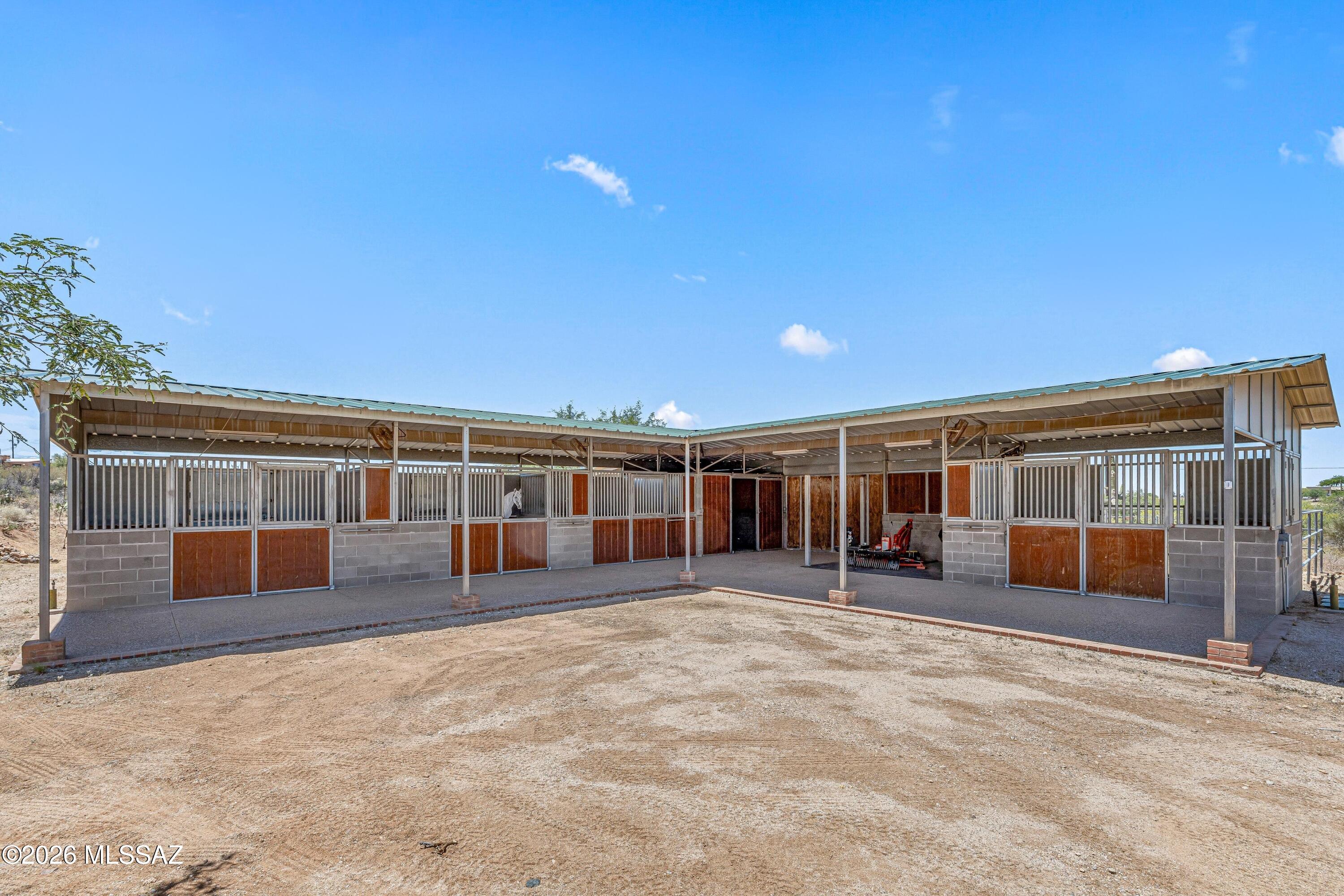 11160 East Golf Links Road Tucson, AZ 85730 - Photo 42 of 51 Equine facilities below the home. 4 stalls, a tack room and covered storage.