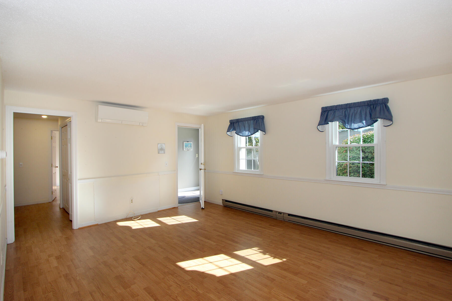 222 Buck Island Road, Unit 53 West Yarmouth, MA 02673 - Photo 5 of 23 an empty room with wooden floor and windows