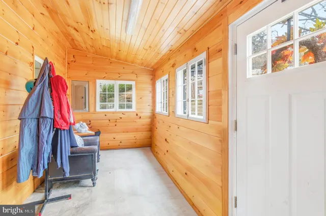 a view of porch with a chair and potted plants