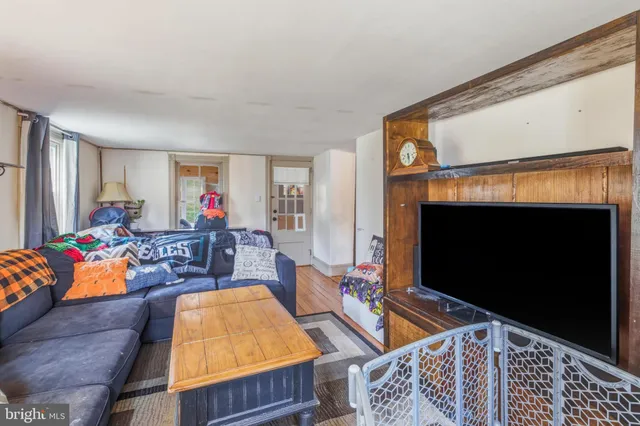 a living room with furniture flat screen tv and a fireplace