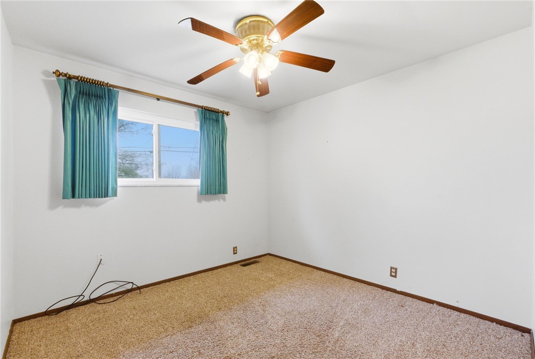 6711 Hamilton-Middletown Road Franklin, OH 45005 - Photo 23 of 49 This cozy bedroom features a ceiling fan, carpeted floor, and a window for natural light.