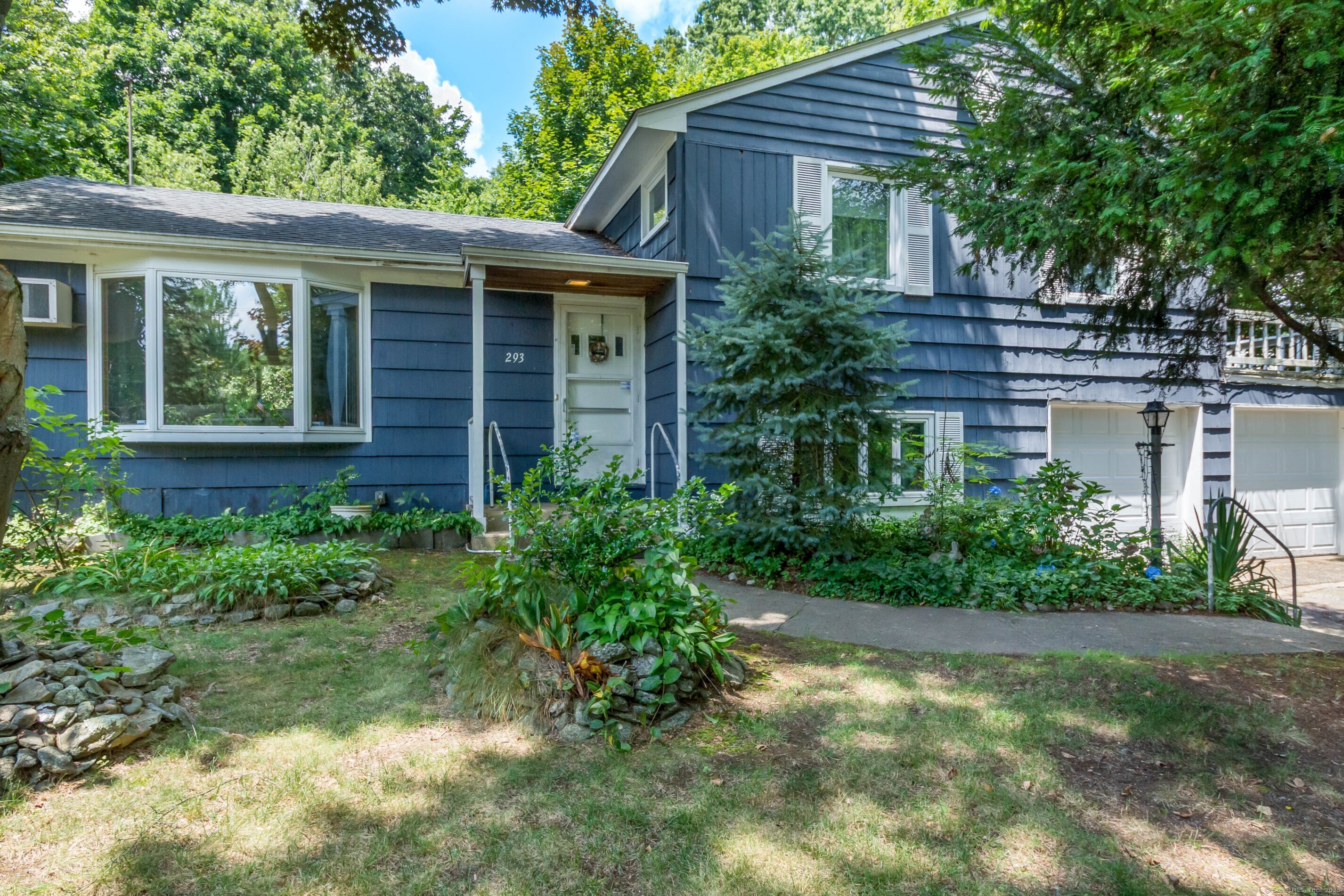 293 Barryscott Drive Fairfield, CT 06825 - Photo 1 of 1 a view of a house with brick walls and a yard with plants