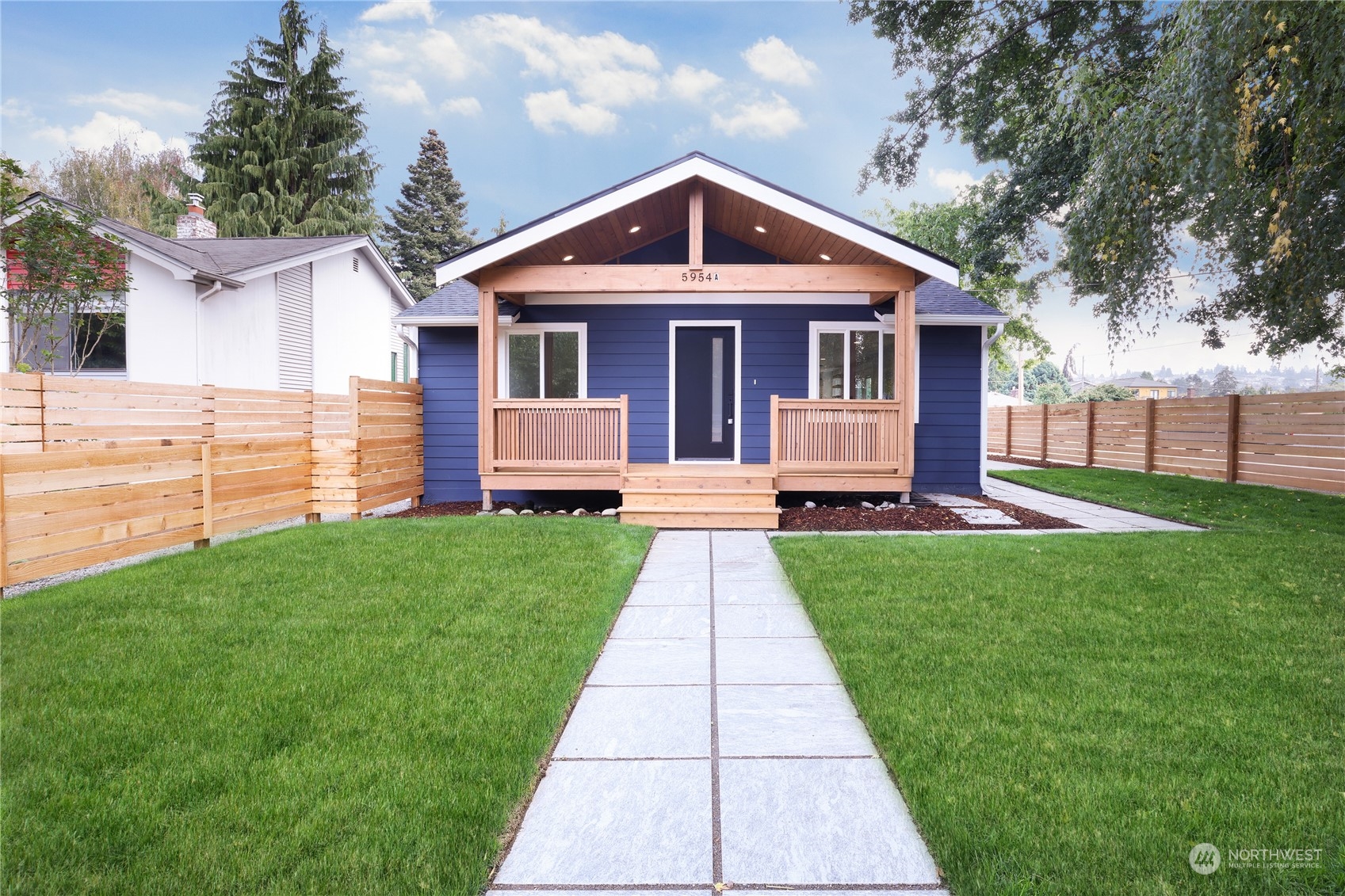 5954 49th Avenue Southwest, Unit A Seattle, WA 98136 - Photo 1 of 12 a front view of a house with a yard
