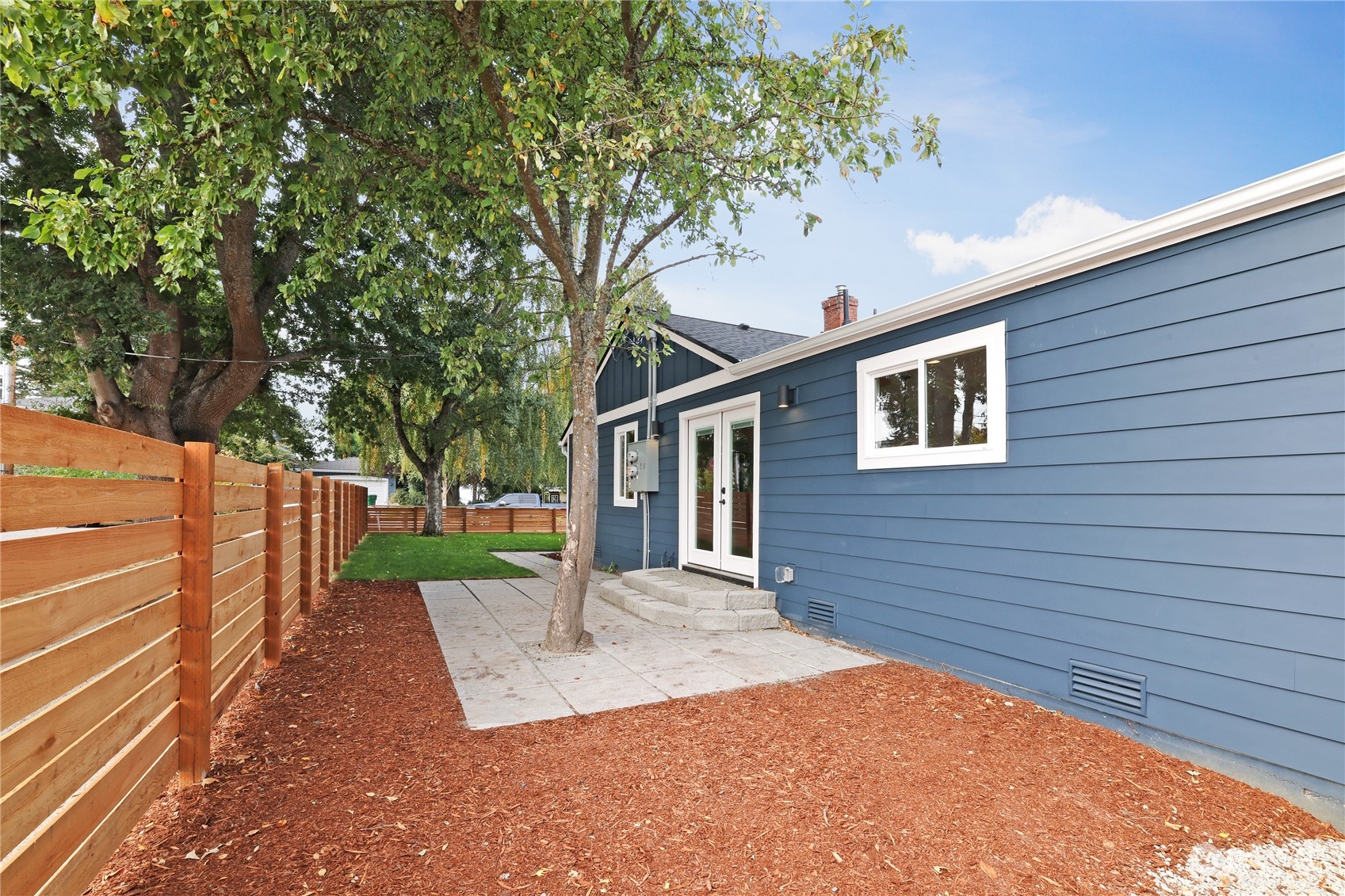 5954 49th Avenue Southwest, Unit A Seattle, WA 98136 - Photo 11 of 12 a front view of a house with a yard