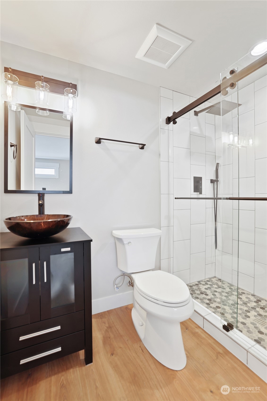 5954 49th Avenue Southwest, Unit A Seattle, WA 98136 - Photo 7 of 12 a bathroom with a toilet a sink and a mirror