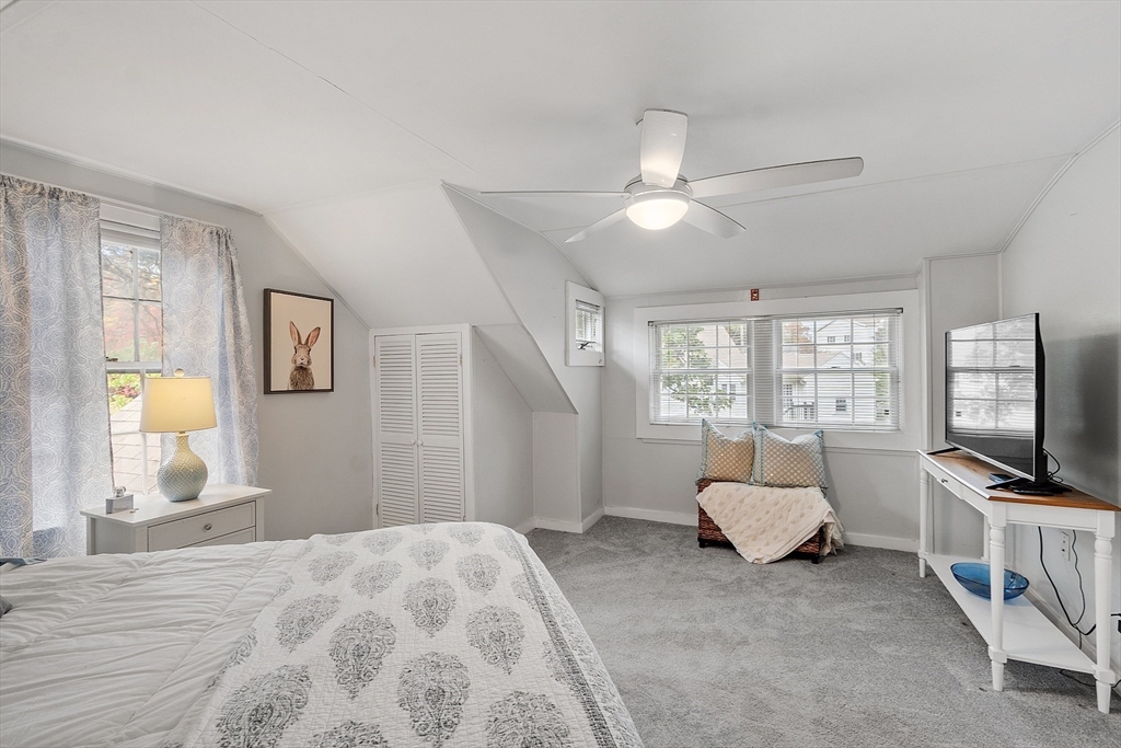 2 Cedarwood Road Lynnfield, MA 01940 - Photo 20 of 40 a spacious bedroom with a bed a couch and a flat tv screen on a dresser