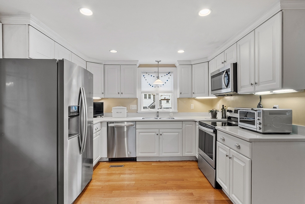 2 Cedarwood Road Lynnfield, MA 01940 - Photo 2 of 40 a kitchen with stainless steel appliances granite countertop a stove top oven a refrigerator a sink and dishwasher