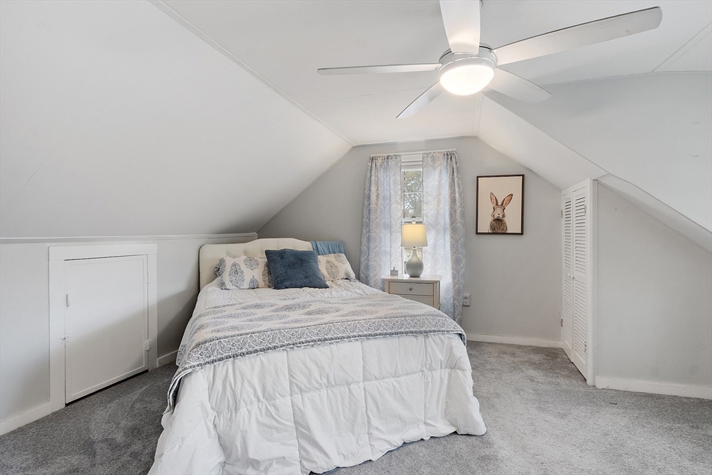 2 Cedarwood Road Lynnfield, MA 01940 - Photo 23 of 40 a bedroom with a bed and a chandelier