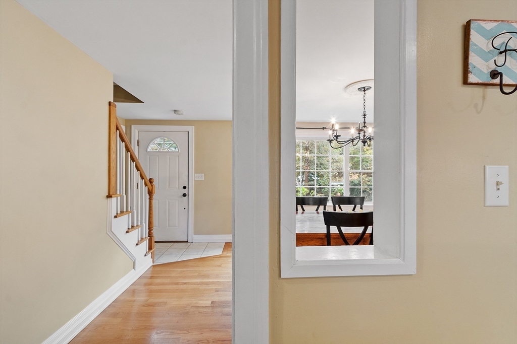 2 Cedarwood Road Lynnfield, MA 01940 - Photo 30 of 40 a view of a hallway with wooden floor and a living room