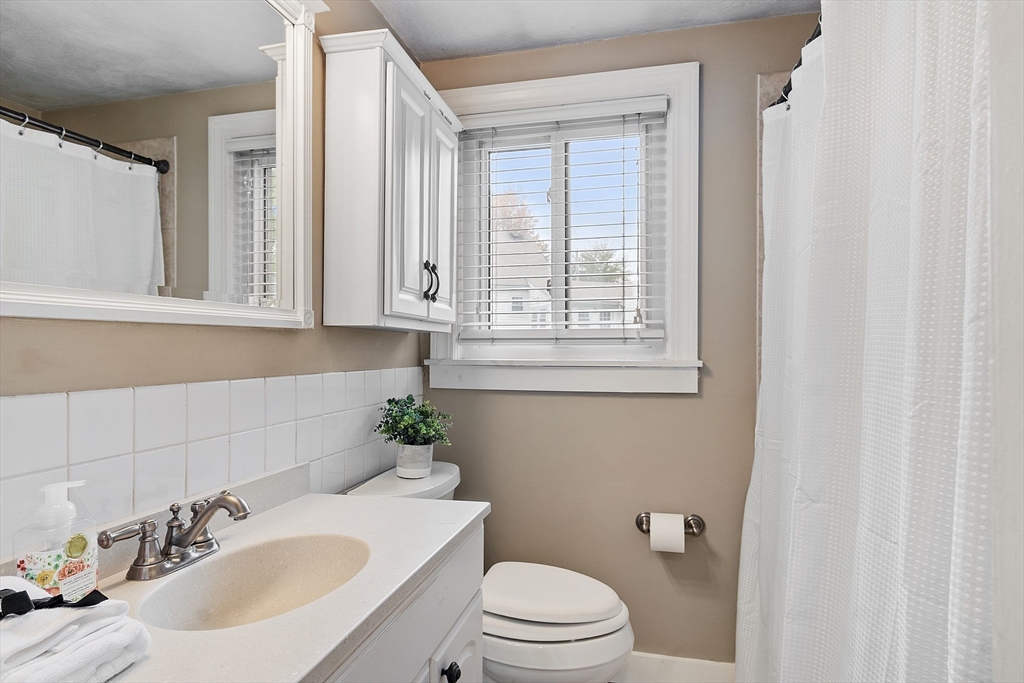 2 Cedarwood Road Lynnfield, MA 01940 - Photo 31 of 40 a bathroom with a sink a toilet and a mirror