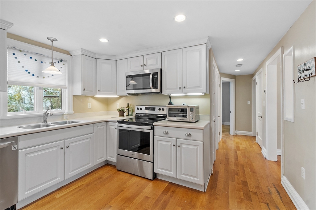 2 Cedarwood Road Lynnfield, MA 01940 - Photo 4 of 40 a kitchen with kitchen island granite countertop a sink cabinets and stainless steel appliances