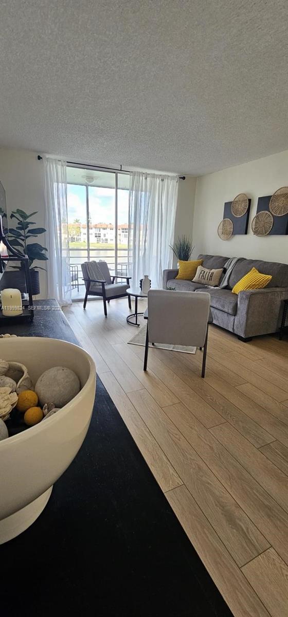 2801 North Pine Island Road, Unit 207 Sunrise, FL 33322 - Photo 11 of 11 a living room with furniture and a large window