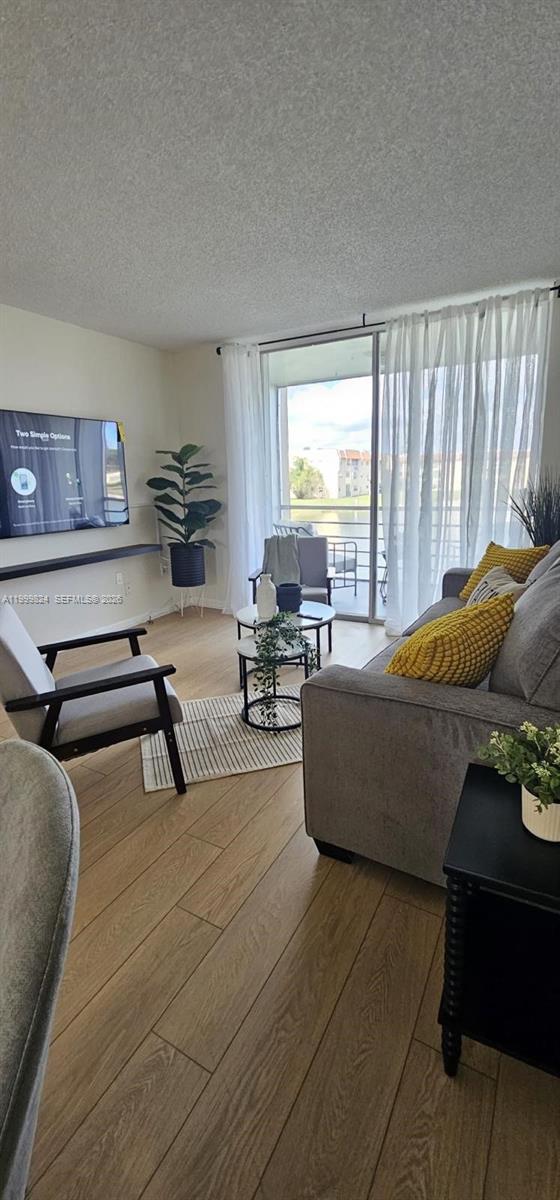 2801 North Pine Island Road, Unit 207 Sunrise, FL 33322 - Photo 5 of 11 a living room with furniture and a large window