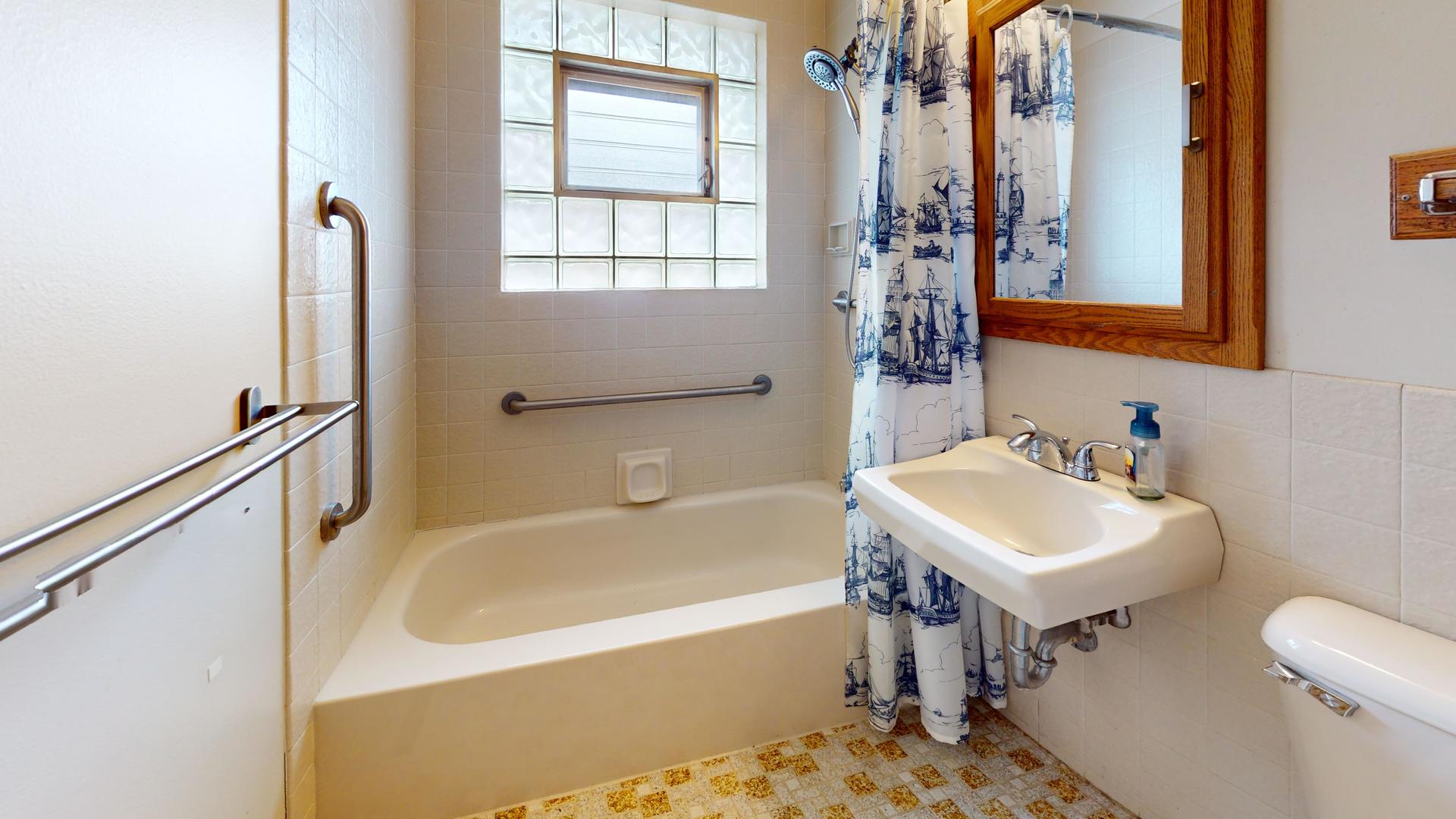 709 South Dennis Road Wheeling, IL 60090 - Photo 11 of 16 a bathroom with a sink and a bathtub
