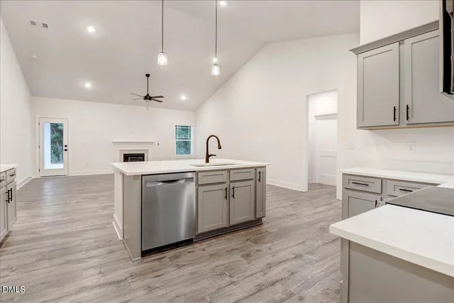 a kitchen with white cabinets and sink